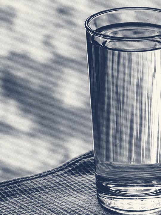 A glass of clear drinking water, advertising a free in-home water test by Jones Air & Water